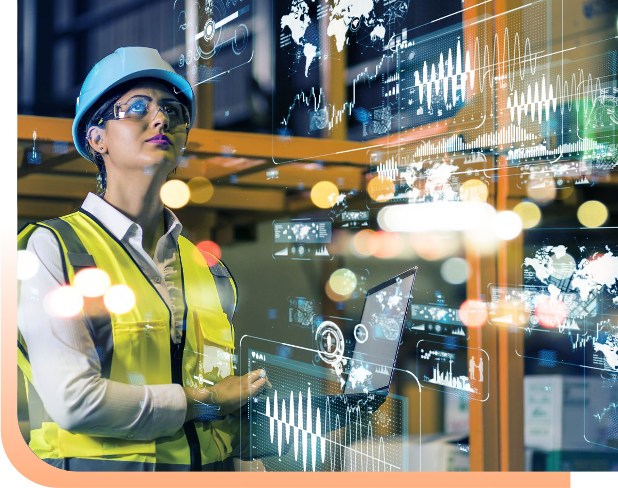 Female engineer in a blue hard hat and yellow safety vest uses a laptop, surrounded by holographic data displays in an industrial setting.